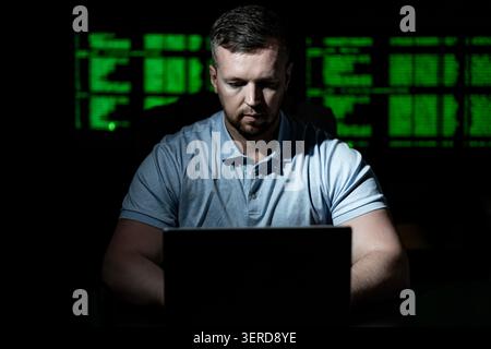 Cyber attack hacker uses computer. Cyber attack hacker writes malicious code. Cyber attack hacker targets network security. Cyber attack hacker Stock Photo