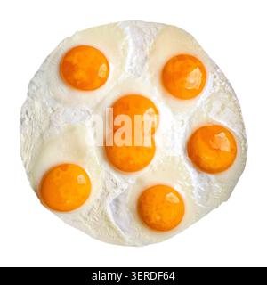 An omelet is made using one giant egg with two yolks and five regular eggs. The dish is shown isolated on a plain background. The yolks are bright and Stock Photo