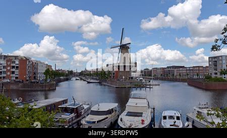 A view of the old Korenmolen de Distilleerketel  corn windmill, in the historic Delfshaven district of  Rotterdam, Netherlands Stock Photo