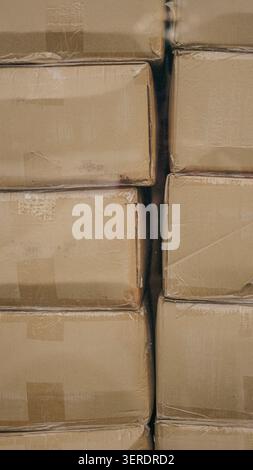 Cardboard boxes stacked in a warehouse closeup. Stock Photo