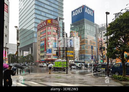 Wet Chuo-dori in Akihabara Electric Town with Aisan Electric and AOKI buildings on a rainy day in Tokyo, Japan. Stock Photo