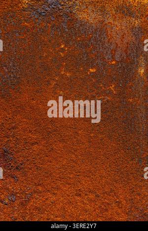 Detailed close-up of a heavily rusted metal surface. The image highlights rough textures and color variations from reddish-brown to dark black, showca Stock Photo