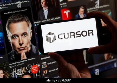 June 18, 2026: In this photo illustration, the Cursor AI logo is displayed on a smartphone screen in front of images of entrepreneur Elon Musk, in New Delhi, India on 18 June 2026. Elon Musk's SpaceX has agreed to acquire AI coding startup Cursor, developed by Anysphere, in a record-breaking all-stock deal valued at Dollar 60 billion. (Credit Image: © David Talukdar/ZUMA Press Wire) EDITORIAL USAGE ONLY! Not for Commercial USAGE! Stock Photo