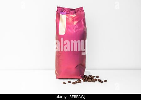 An airtight bag of coffee beans on a white surface. Stock Photo