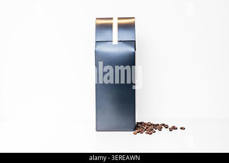 A dark green airtight box with coffee beans on a white surface. Stock Photo