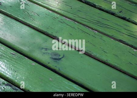 Bright green wooden boards reflect sunlight, bringing life to the outdoor setting. Stock Photo