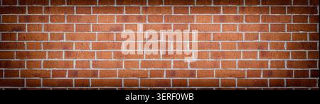 Wide red brick wall texture. Rough orange brickwork widescreen backdrop. Large long abstract background Stock Photo