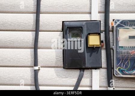 Modern Outdoor Electrical Meter and Distribution Panel Installed on Residential House Wall Stock Photo