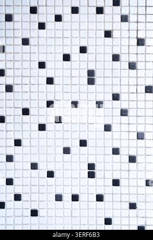 A black and white mosaic tile texture with a random pixel pattern. Concept: Minimalist interior design, modern wall cladding, and geometric backdrops Stock Photo