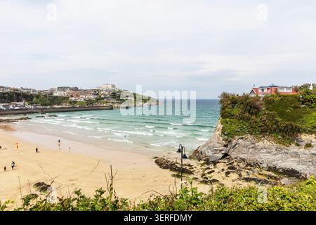 Newquay, Cornwall, UK, England, Towan Beach in Newquay, Cornwall, England. The image shows gentle waves rolling into the beach with a few distant peop Stock Photo