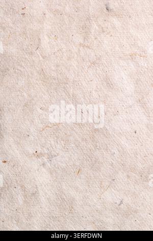 Textured beige wrinkled handmade paper background. Vertical background for design Stock Photo