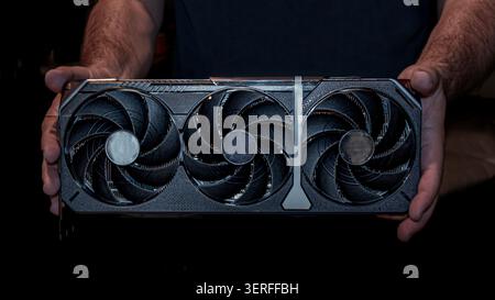 Man Holding Modern Graphics Card for Computer Upgrade Stock Photo