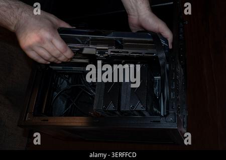 Installing Graphics Card in Open Desktop Computer Case Stock Photo