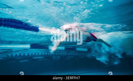 Swimmer moving fast through water with motion blur Stock Photo