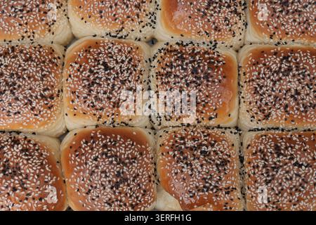 Freshly baked buns with sesame seeds on top Stock Photo