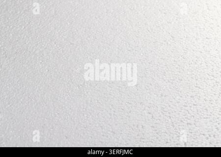 White foam with characteristic bubbles, this foam has a matte surface and consists of round polystyrene foam elements. Stock Photo