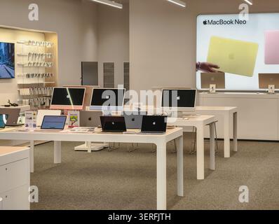 Prague, Czech Republic - June 18, 2026: Interior view of an Apple retail store with computers, laptops and illuminated product displays electronics Stock Photo