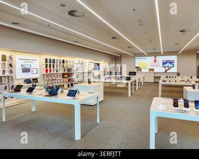 Prague, Czech Republic - June 18, 2026: Interior of an Apple Store displaying smartphones, tablets, laptops and accessories in a retail environment Stock Photo