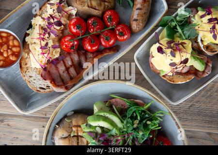 Delicious Brunch Spread With Colorful Dishes and Fresh Ingredients on Wooden Table Stock Photo