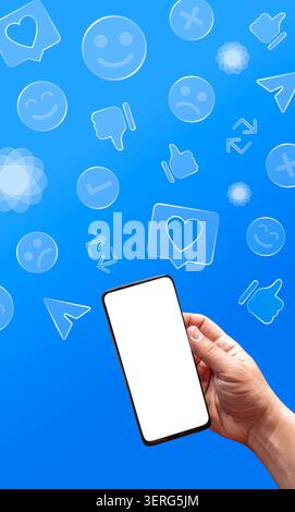 Hand holding smartphone with blank screen, social media icons floating on a blue background Stock Photo