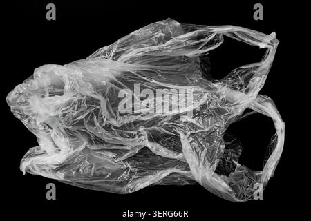 Crumpled Transparent Plastic Shopping Bag on Solid Black Background Stock Photo