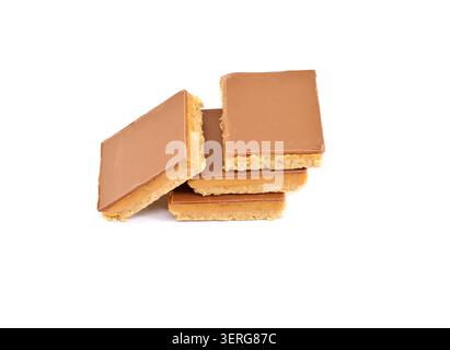 Caramel shortcakes, or shortbread, on white background. They are biscuits made of shortbread topped with caramel and chocolate. Stock Photo