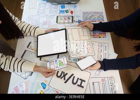 UX UI designers collaborating on mobile app wireframe and user interface design Stock Photo