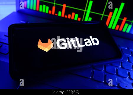 GitLab Inc DevOps Software Development Platform Company Logo Displayed On Mobile Phone Screen With Stock Market Chart Background Stock Photo