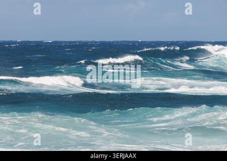 Four sequential swirling waves forming a diagonal line in a raging Atlantic Ocean, coast of São Miguel Island, Azores, Portugal Stock Photo