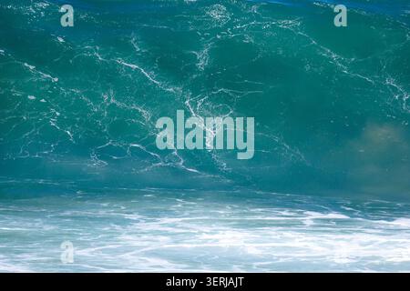 An abstract close-up shot of the interior of a colorful blue and green ocean wave at Vilanova de Gaia beach in Portugal. Stock Photo