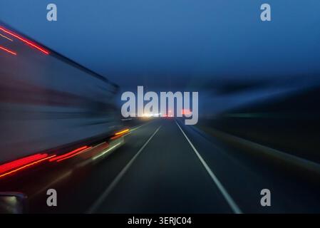 View of a highway at night with light trails from cars Stock Photo