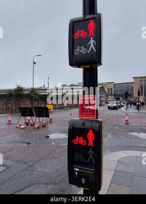 Traffic signal for pedestrians and cyclists in Glasgow, Scotland, featuring a touchless push button instruction panel. Stock Photo