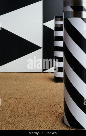 Patterns on wall and bollard with yellow ground Stock Photo