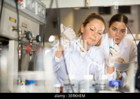 Confident women technicians working in research laboratory Stock Photo