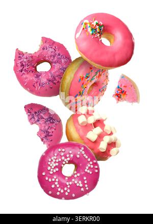 Yummy donuts covered with icing falling on white background Stock Photo