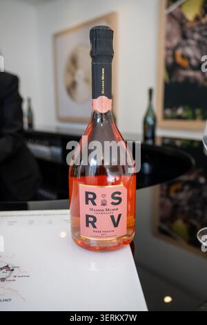 Reims, France - 8 Mar 25: Close-up of Maison Mumm RSRV Rose champagne bottle on a tasting table in Reims, France, with blurred tasting room background Stock Photo
