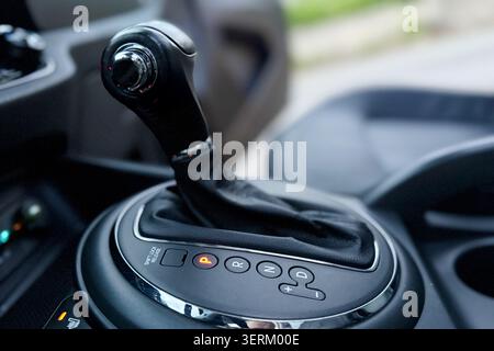 Automatic transmission gear shift stick in a modern car luxury interior. Close up of automatic gear selector lever. Car gearbox handle with parking po Stock Photo