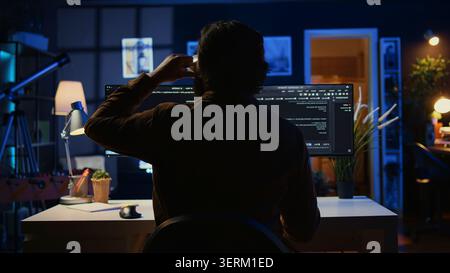 Software engineer writes complex binary code scripts on computer, close-up, teleworking IT specialist in home office using programming to safeguard consumer data, handheld hot. Stock Photo