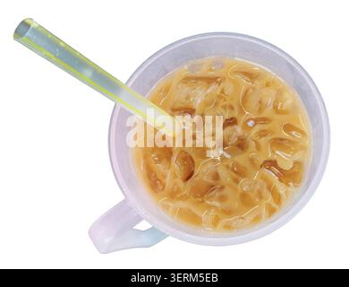 An overhead shot of refreshing iced milk coffee or tea filled with ice cubes, served in a light pink plastic cup with a yellow-striped straw, isolated Stock Photo