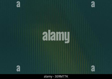 A dark, moody abstract background showing a subtle gradient of green and yellow hues overlaid with a vertical ribbed or corrugated texture pattern. Stock Photo