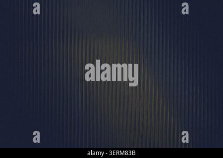 A dark blue background featuring a subtle vertical ribbed texture with a soft golden light highlight in the center, creating a moody and elegant effec Stock Photo