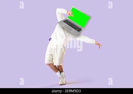 Creative digital content creator with laptop head and green screen display, modern technology and online communication, the blank green screen provide Stock Photo