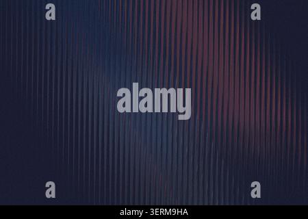 An abstract textured background featuring vertical ribbed lines with a deep, dark blue and subtle red gradient effect. Stock Photo