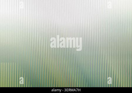 An abstract background composed of vertical lines with a soft, grainy texture, transitioning from a light top to a deep green bottom. Stock Photo