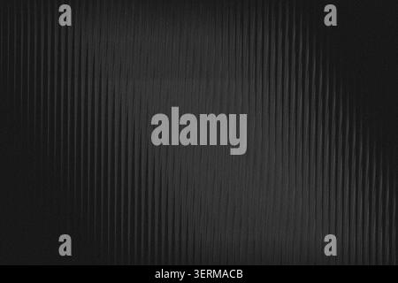 A dark, moody abstract background characterized by vertical lines and a distinct grainy texture, providing a sophisticated and minimalist aesthetic. Stock Photo