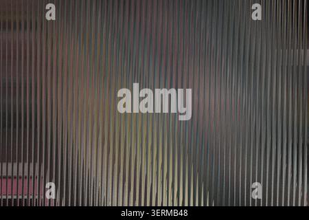 A textured background featuring vertical lines with a soft, multi-colored gradient effect, creating a sense of depth and modern aesthetic. Stock Photo