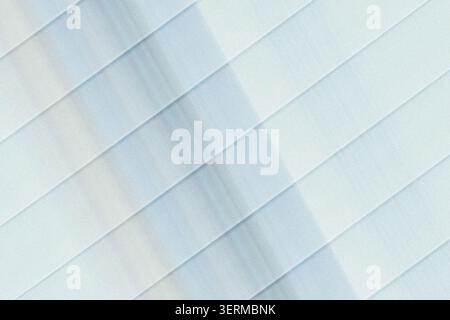An abstract background featuring diagonal parallel lines with a soft blue gradient effect, creating a sense of movement and depth. Stock Photo