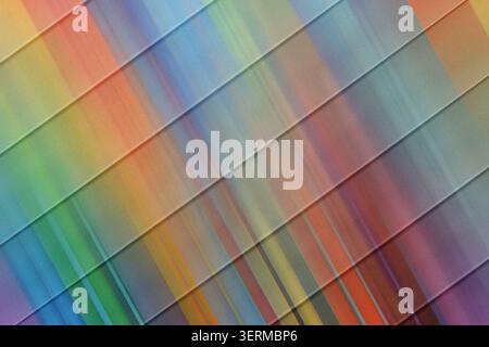An energetic abstract background composed of diagonal stripes overlaid with dynamic, colorful light streaks and a textured grain effect. Stock Photo