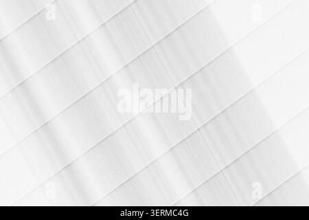 A high-contrast monochrome abstract background featuring diagonal stripes with a brushed metallic texture and soft light gradients, isolated on white Stock Photo