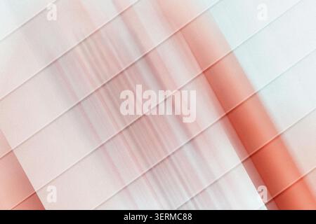 An abstract digital art background featuring parallel diagonal lines overlaid on a soft, blurred red and white gradient with a subtle grainy texture. Stock Photo